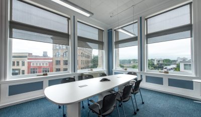 The Hudson Conference room, empty, with the windows facing downtown Troy.