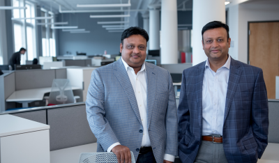 Pictured are two men in an office. Pictured left is Vikram Agrawal and right is Vikash Agrawal.